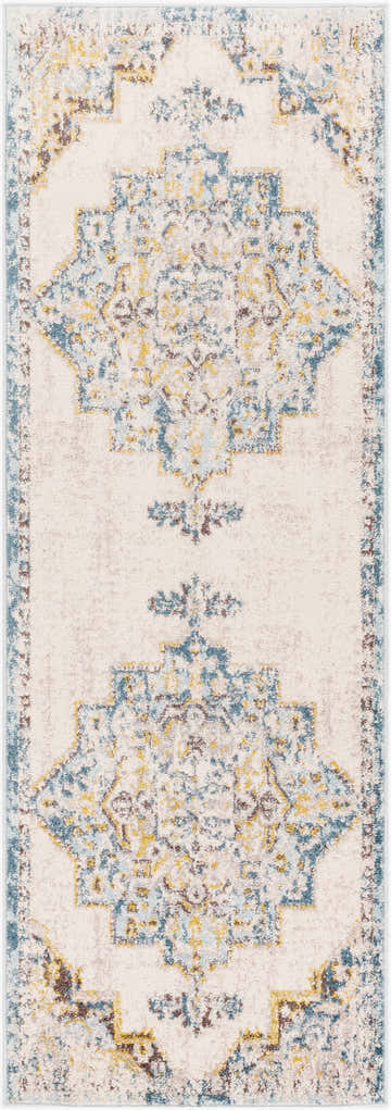 Close-up of the Nibley Area Rug. Features a vintage, bohemian design in blue, mustard, and brown tones on a light gray background. Design-Runner-2773