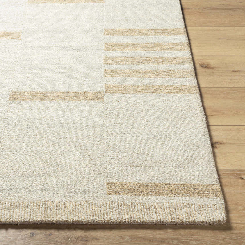 Close up of the hand tufted Nadav Beige Area Rug showing the wool texture and tan geometric pattern. Front