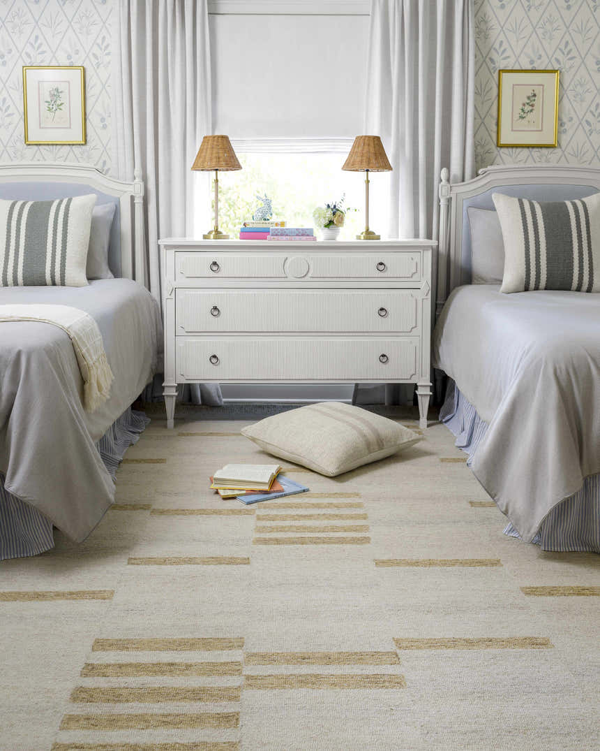 Light and airy kids bedroom with two beds featuring the Nadav Beige Area Rug. Roomscene-Rectangle