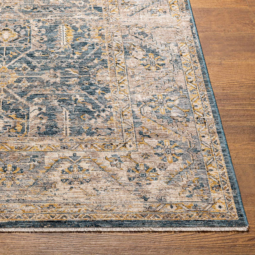Close-up of the Odala Luxe Performance Rug showing its blue, beige, and gold traditional pattern and soft texture. Front