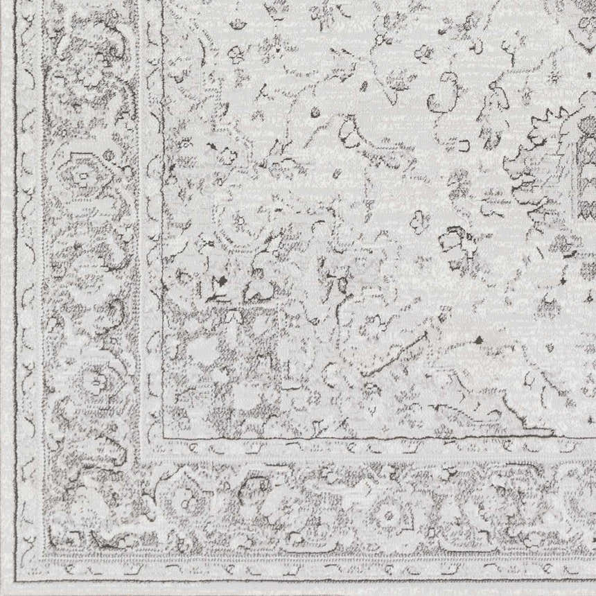 Close up of the Okehampton Area Rug, a farmhouse style rug in charcoal, light gray, and white. Swatch