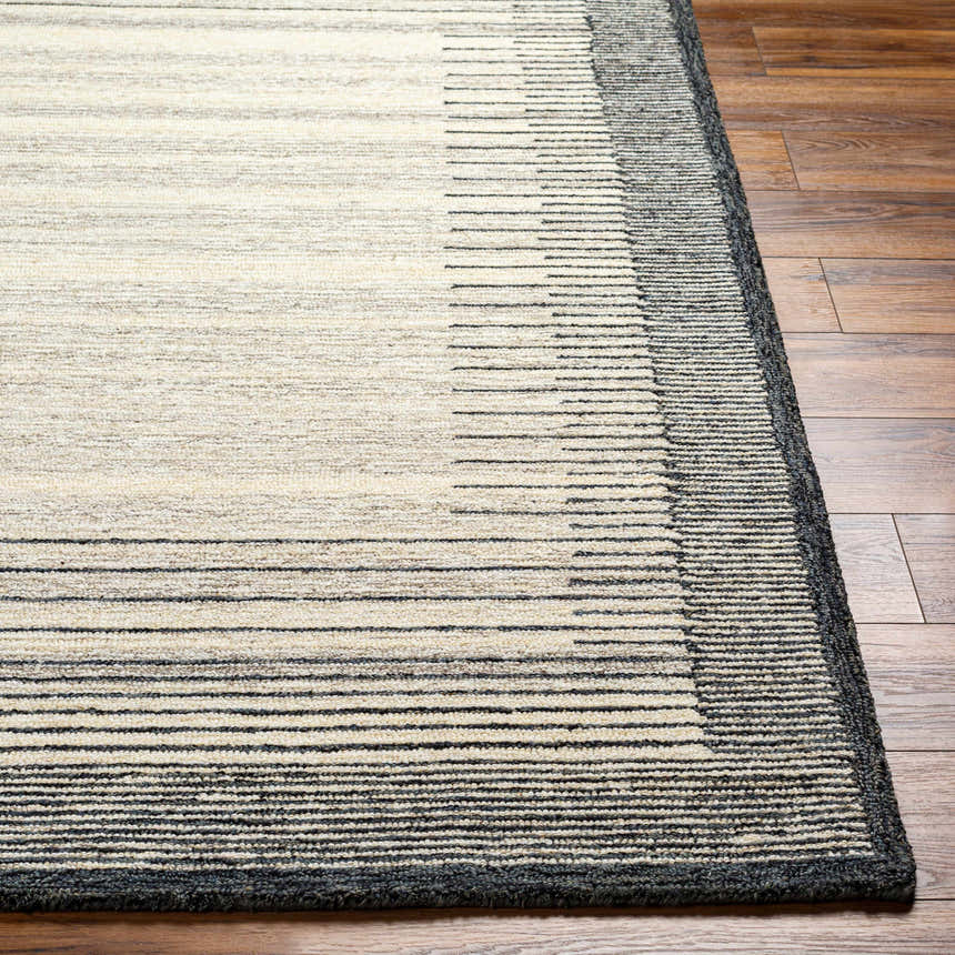 Close-up of the Omeo Wool Area Rug showing bone and dark gray horizontal stripes on a textured, hand-tufted surface. Front
