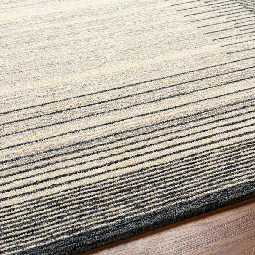 Close up of the Omeo Wool Area Rug showing bone and dark gray stripes and hand tufted texture. Texture