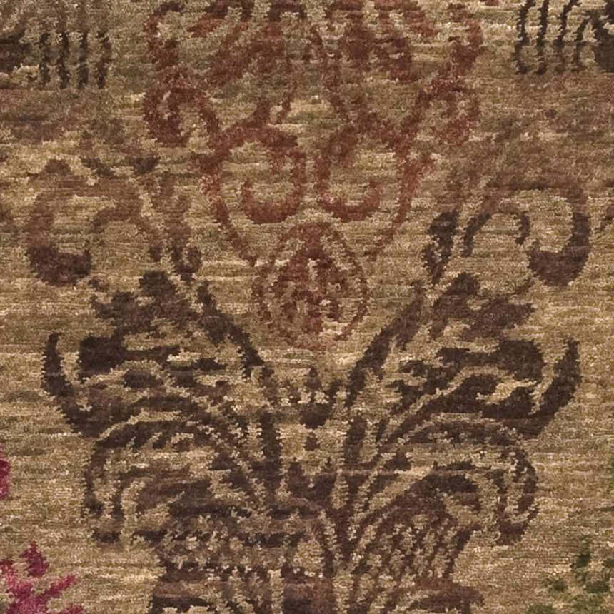 Close-up of the Onaka Area Carpet, a hand-knotted wool rug with a traditional floral pattern in brown, red, and olive tones. Swatch