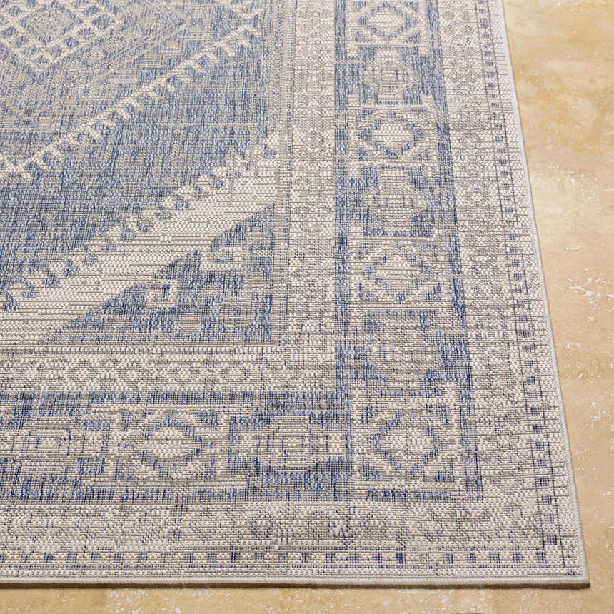 Close up of the blue and gray geometric pattern on the Umraniye Gray Area Rug. Front