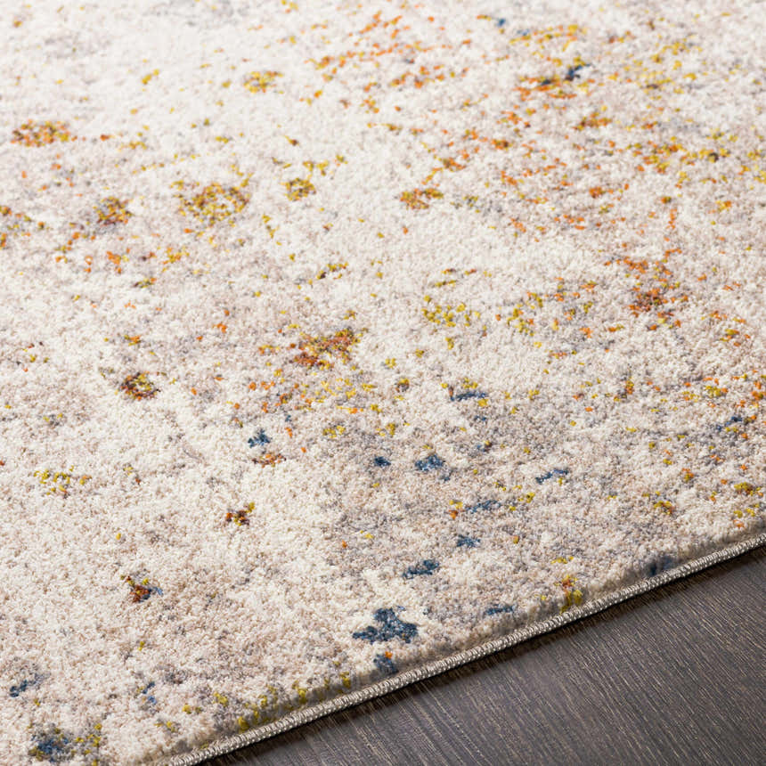 Close up of the Palhi Area Carpet. Cream rug with brick red, mustard, and dark blue accents. Contemporary style. Texture