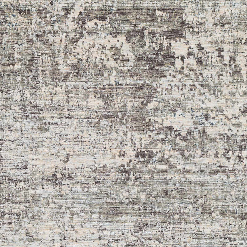 Close-up of the Penokee Carved Statement Rug. Abstract pattern in shades of gray, charcoal, ivory, and light olive. Swatch