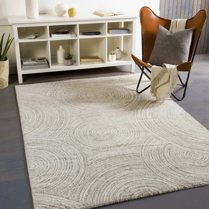 Living room scene with a cream Pirton Luxe Rug featuring a subtle concentric circle pattern. Roomscene-Rectangle