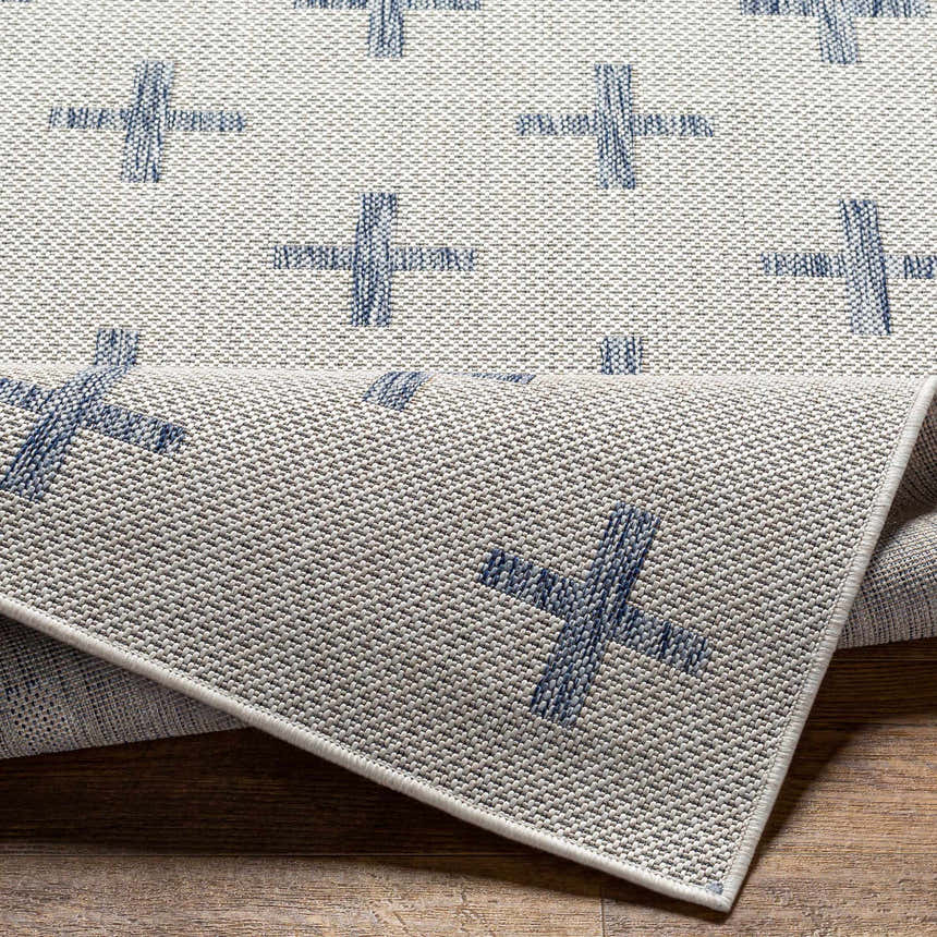 Close-up of Pangao Area Rug showing cream and dark gray woven texture with a geometric plus sign pattern. Fold