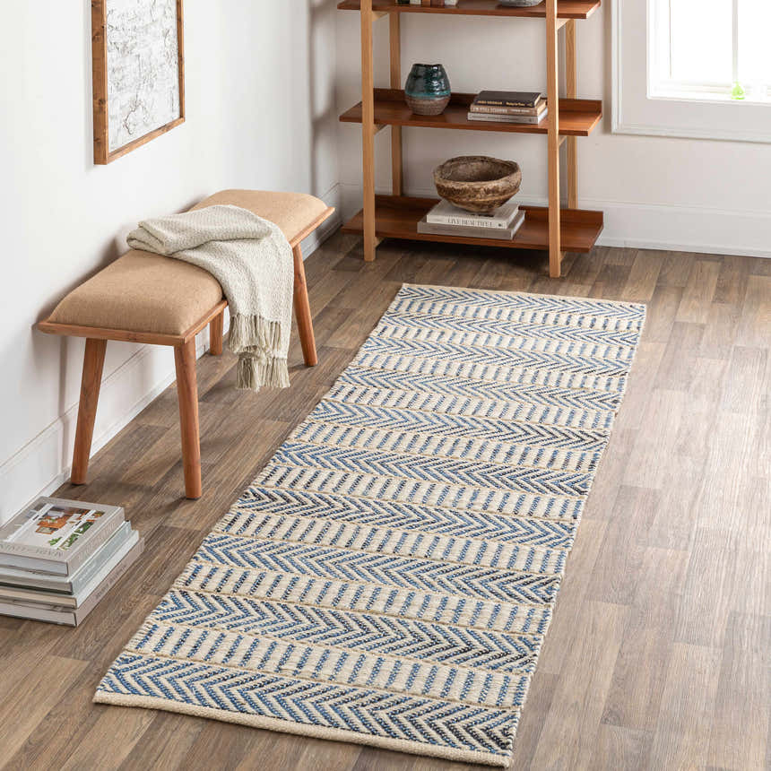 Entryway with Pontian Area Rug runner in blue and beige jute, styled with wood bench and bookshelf. Roomscene-Runner