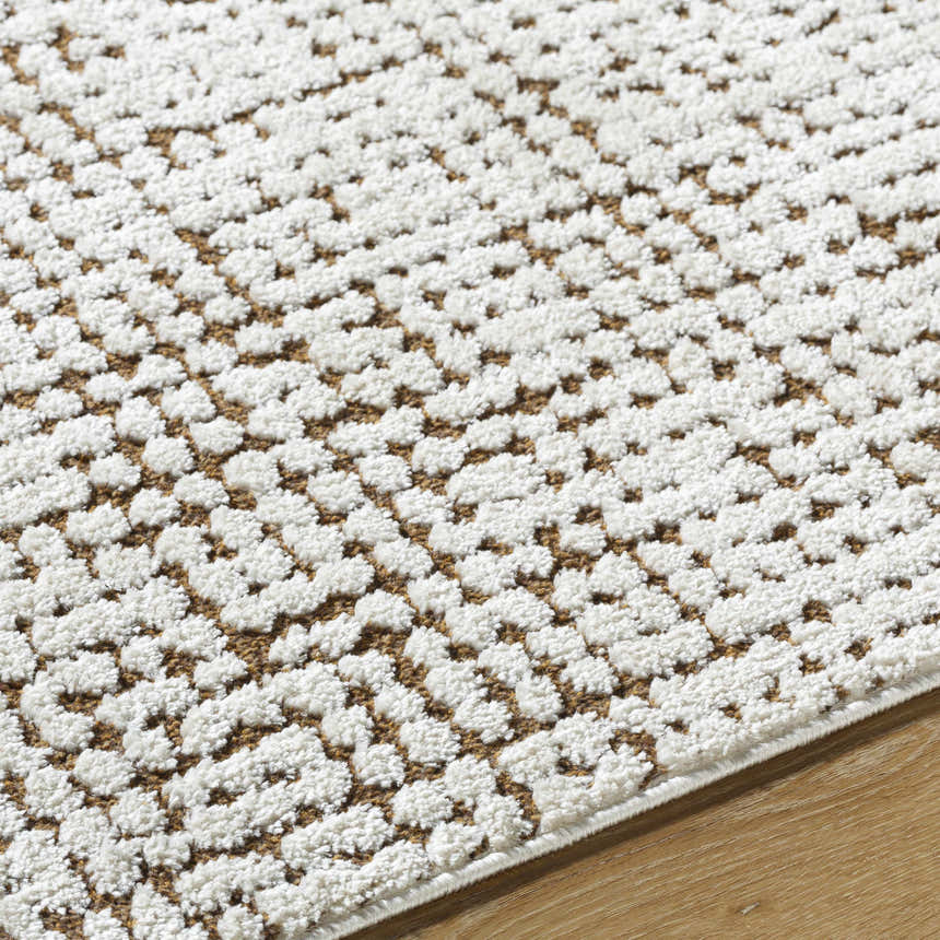 Close-up of the Cascade Minimalist Rug. Ivory and medium brown geometric pattern with a soft, textured pile. Texture
