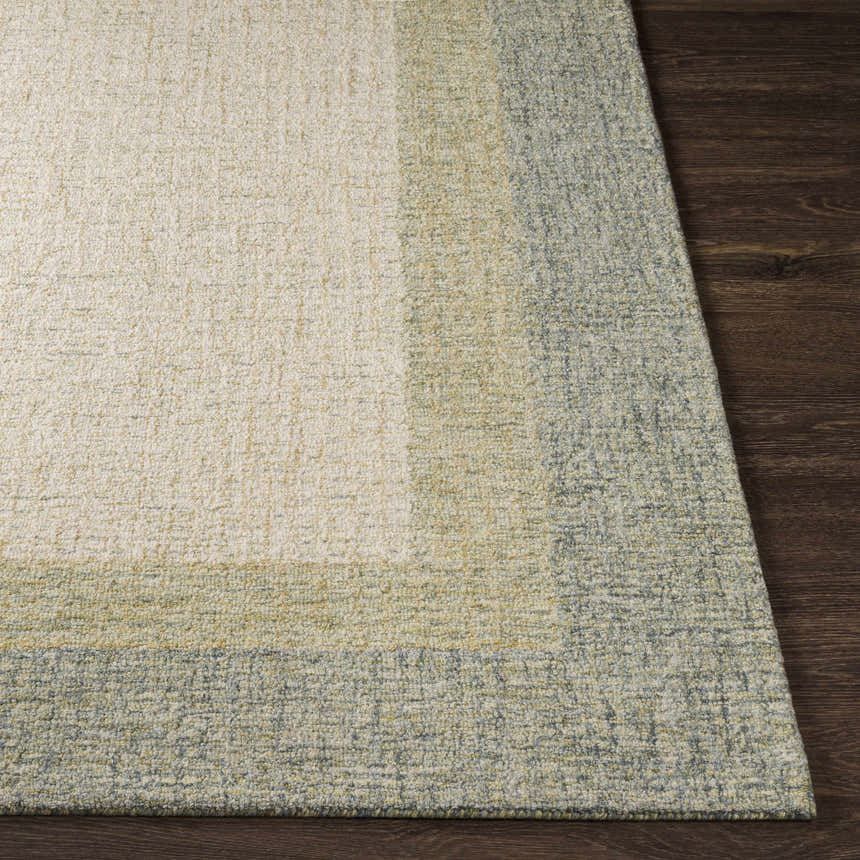 Close-up of the hand-tufted Pualas Area Rug. Cream, sage, and light beige wool with a solid and striped contemporary design. Front