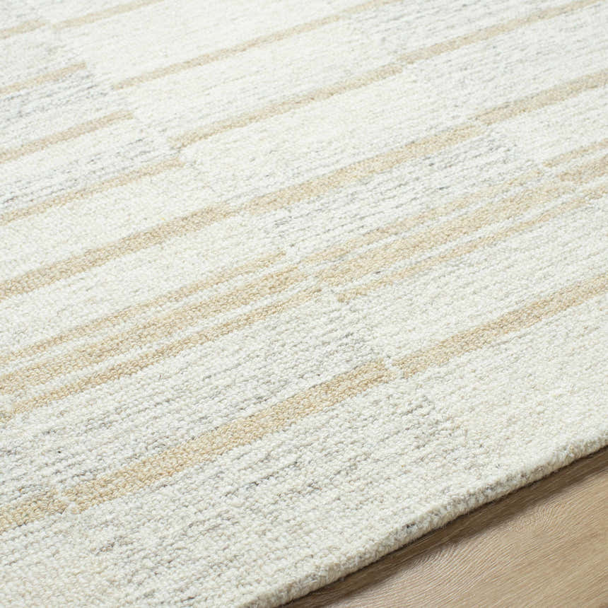 Close-up of the Paiva Modern Wool Rug. Cream wool rug with tan and taupe stripes. Hand-tufted texture. Texture