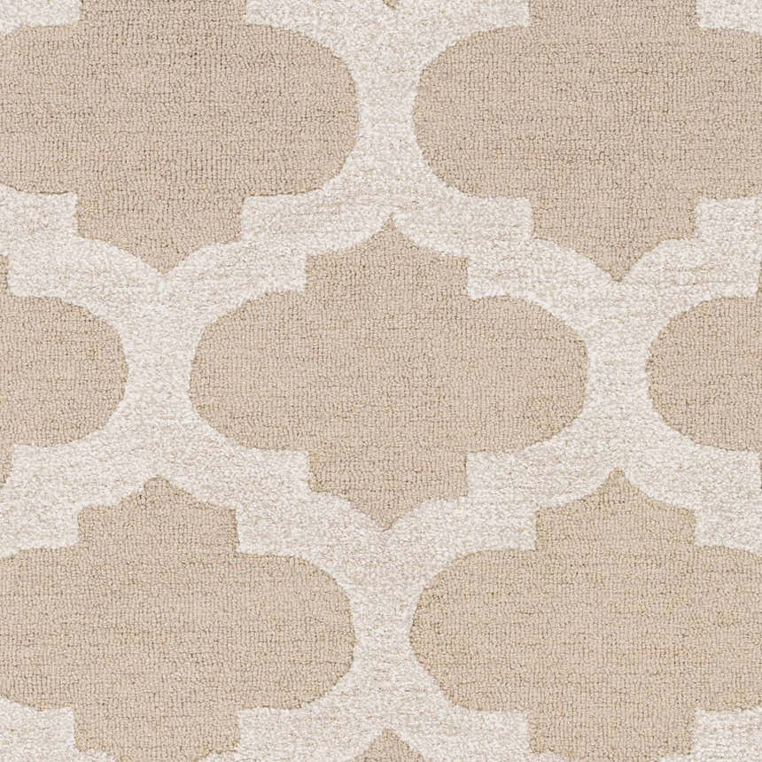 Close-up of the Quicksand Area Rug showing a neutral quatrefoil pattern and hand-tufted wool texture. Swatch