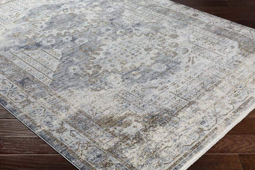 Close-up of the Randalia Area Rug showcasing its ivory, gray, and brown traditional pattern and soft texture. Corner