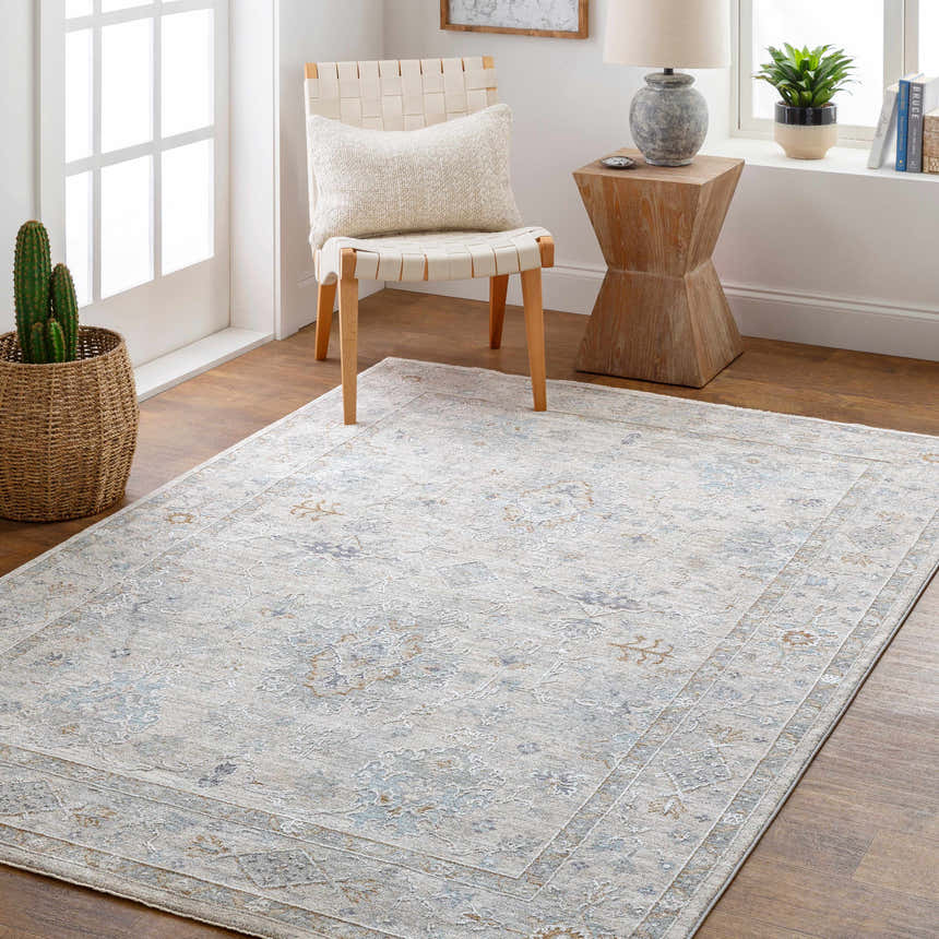 Entryway with Rochedale Area Rug in cream, lavender, and blue. Woven chair, wood table, and cactus add a farmhouse feel. Roomscene-Rectangle