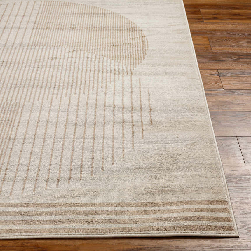 Close-up of the Zeke Geometric Nutmeg Rug showing its linear and circular pattern in brown and cream on wood flooring. Front