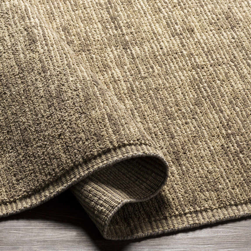 Close-up of a textured Real Area Rug - Clearance in medium gray and peach tones. Fold