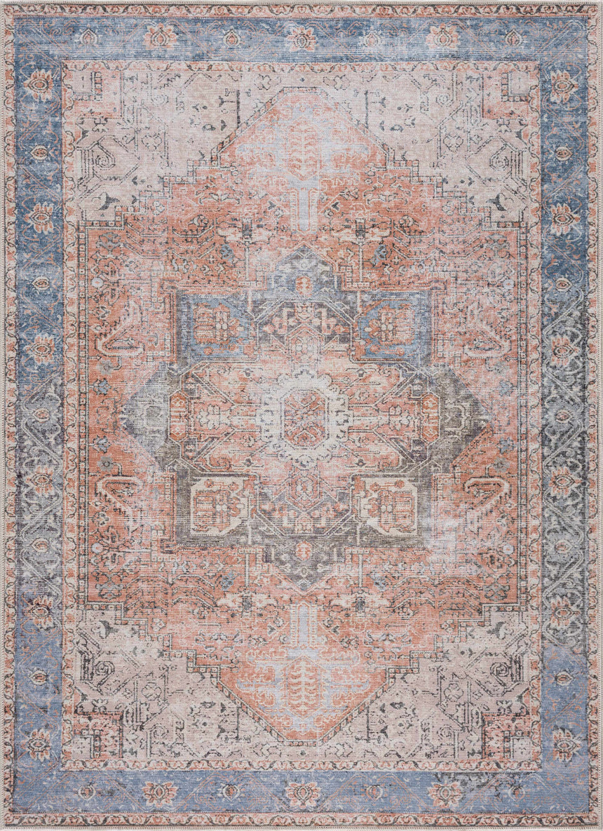 A traditional medallion-patterned washable rug with a vintage look, featuring a mix of red, orange, and blue colors, and flat woven structure.