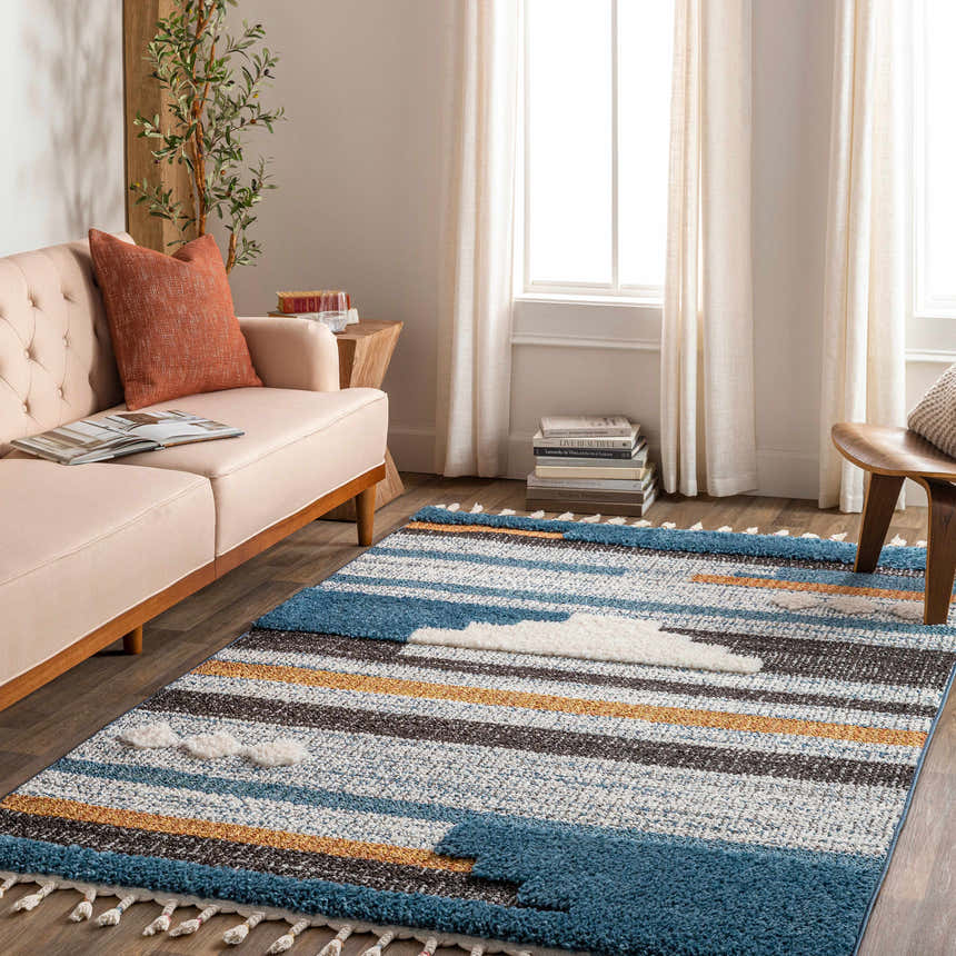 Living room scene with a Rosslare Area Rug in blue, camel, and gray stripes with cloud accents. Roomscene-Rectangle