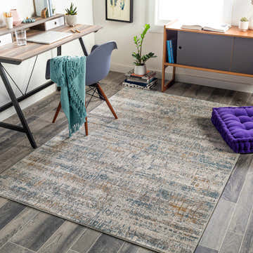 Home office with Runa Area Rug in blue, brown, gray, and mustard colors. Contemporary rug styled with desk, chair, and purple cushion. Roomscene-Rectangle