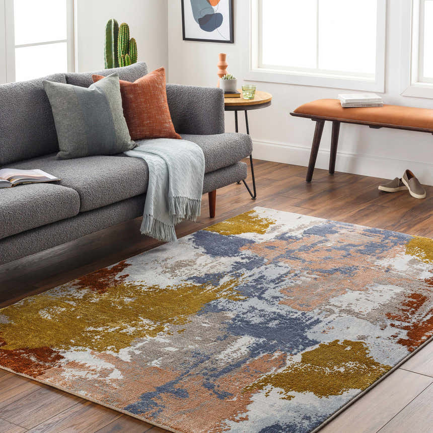 Living room scene with gray sofa and colorful Rivers Area Rug in brick red, blue, mustard, pink, and gray. Roomscene-Rectangle