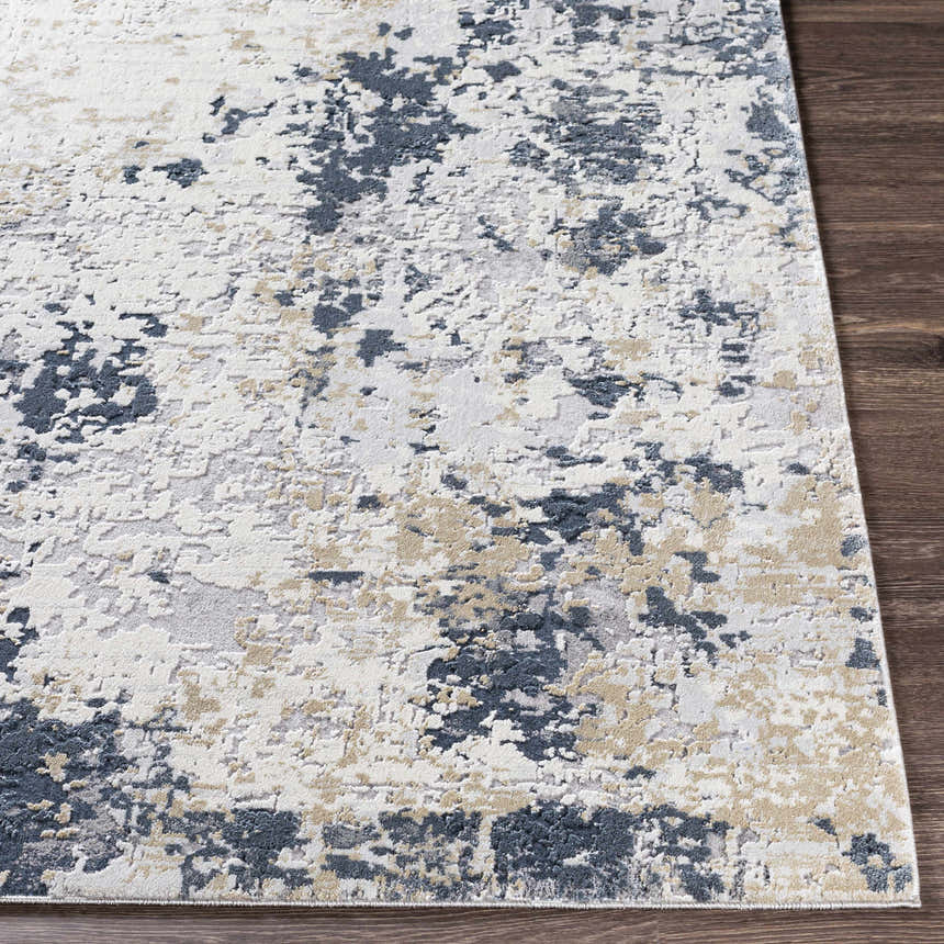 Close-up of the Ryhill Textured Luxe Area Rug showing charcoal, beige, and gray abstract pattern and textured weave. Front