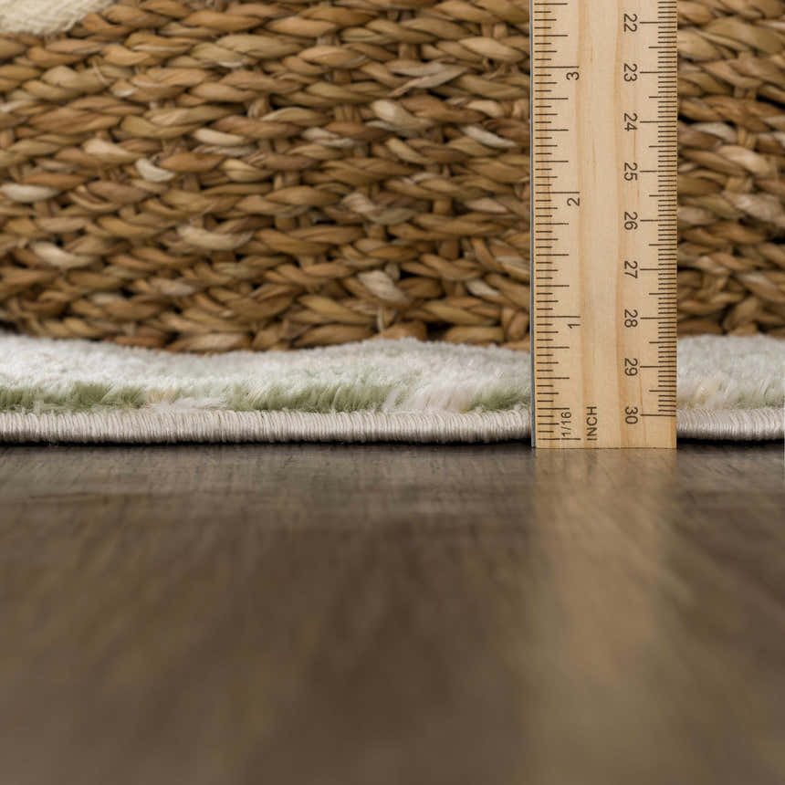 Close-up of Lively Marble Green Area Rug showing pile height with ruler and rug backing texture. Pile