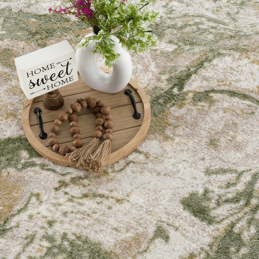 Close-up of Lively Marble Green Area Rug showing cream and green abstract pattern and soft texture. Styleshot