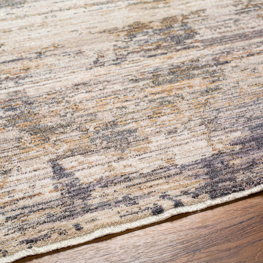 Close-up of the Asuna Area Rug showing its beige, brown and gray contemporary pattern and soft texture. Texture