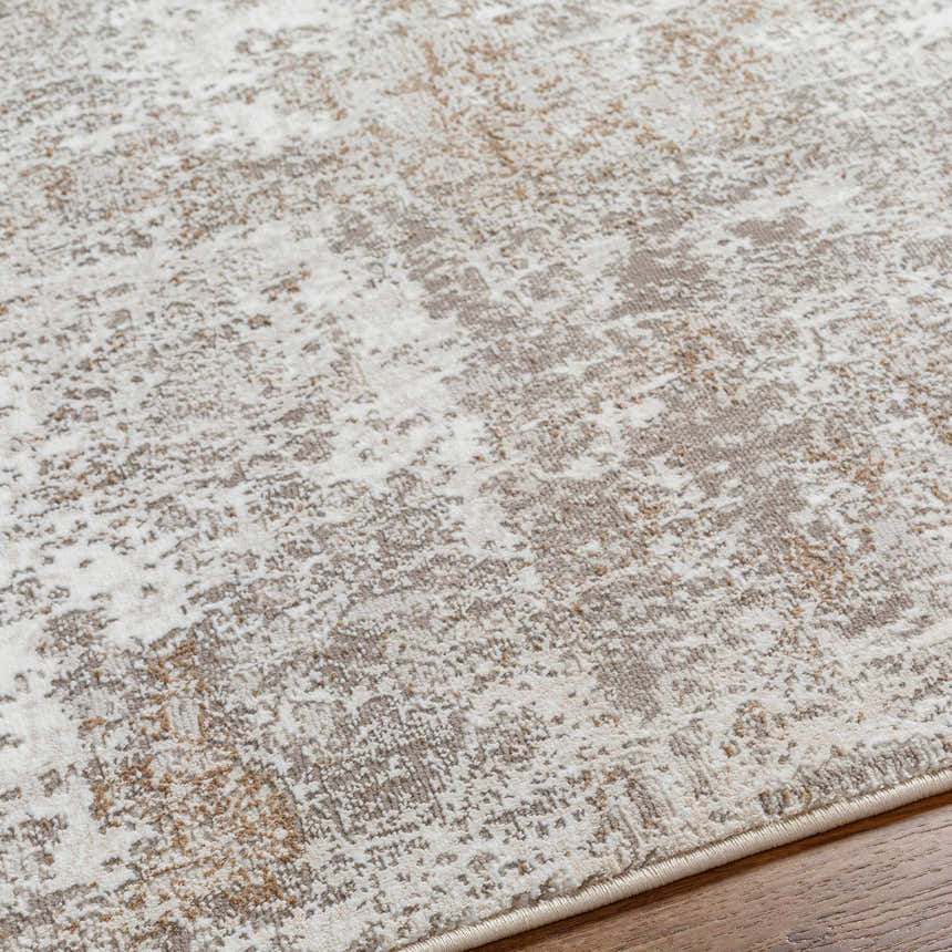 Close-up of the Bruna Area Rug showing its ivory, gray, and brown abstract pattern and soft texture. Texture
