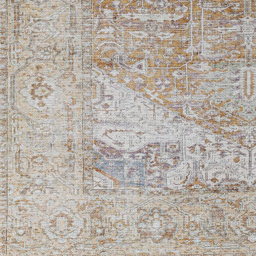 Close-up of the Amato Mustard Washable Area Rug. Traditional farmhouse style with mustard, cream, and purple tones. Swatch