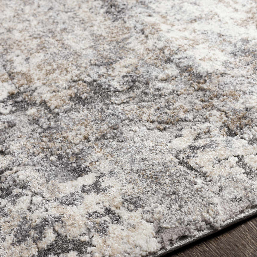 Close-up of the Satsop Rock Pattern Thick Rug. Abstract design in black, charcoal, gray, ivory, and tan. Soft texture. Texture