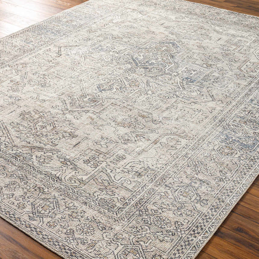 Close-up of the Margot Medallion Light Gray rug. Farmhouse style rug with brown, gray, and light blue tones. Corner