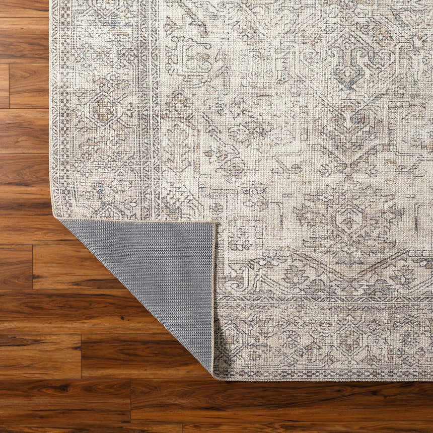 Close-up of the Margot Medallion Light Gray rug showing its traditional pattern, light gray, brown, and charcoal colors. Fold