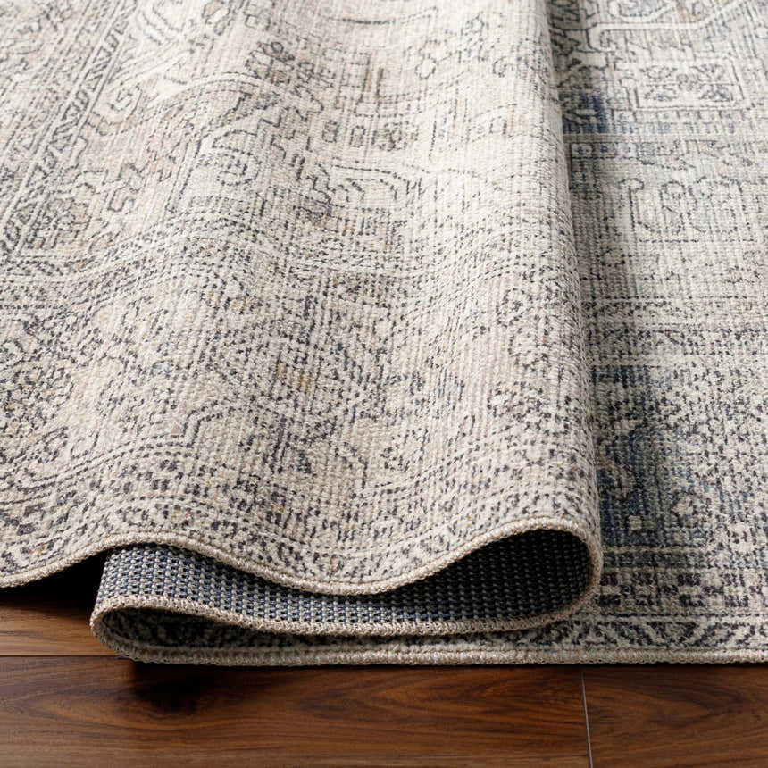 Close-up of the Margot Medallion Light Gray rug showing its traditional pattern, light gray, brown, and charcoal colors. Fold