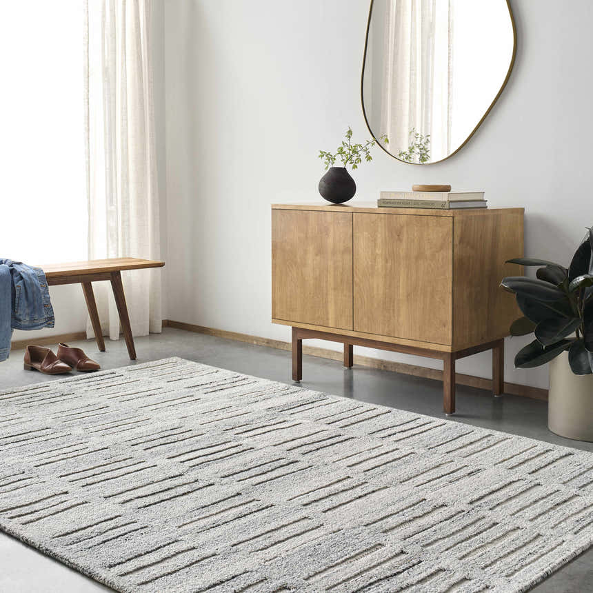 Entryway with light gray Darcy Area Rug, wood cabinet, bench, and oval mirror. Modern, neutral tones. Roomscene-Rectangle