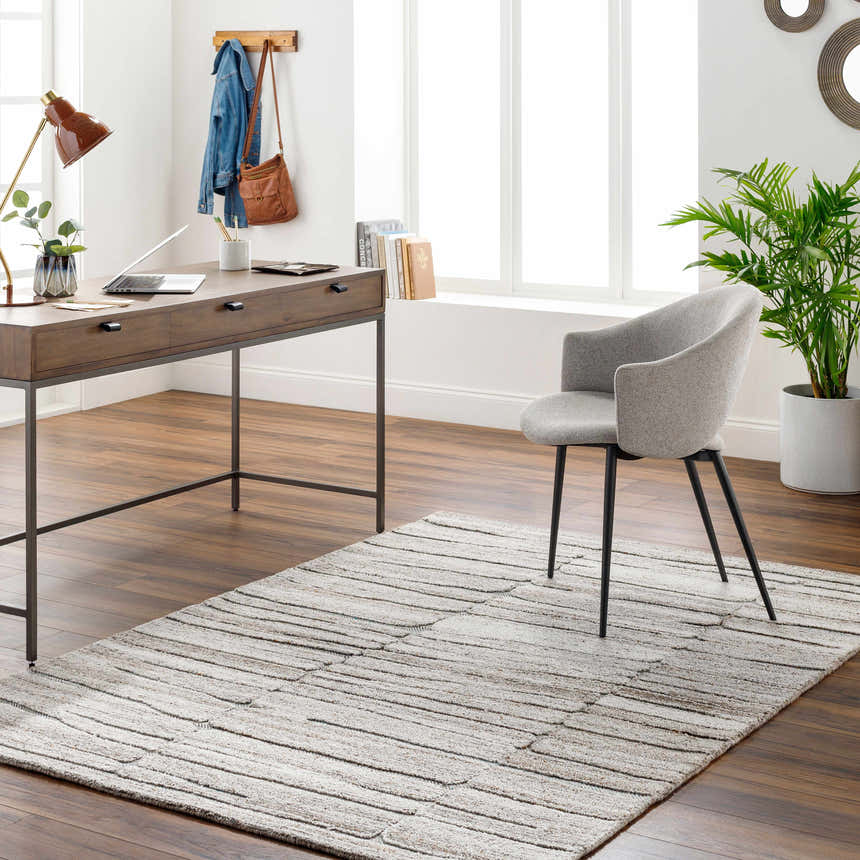 Home office with wood desk, gray chair, and neutral Ebba Area Rug with subtle stripes on dark wood floor. Roomscene-Rectangle