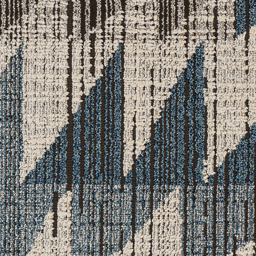 Close-up of Zaim Area Rug showing geometric pattern in blue, cream, and brown. Machine woven texture. Bohemian style. Swatch