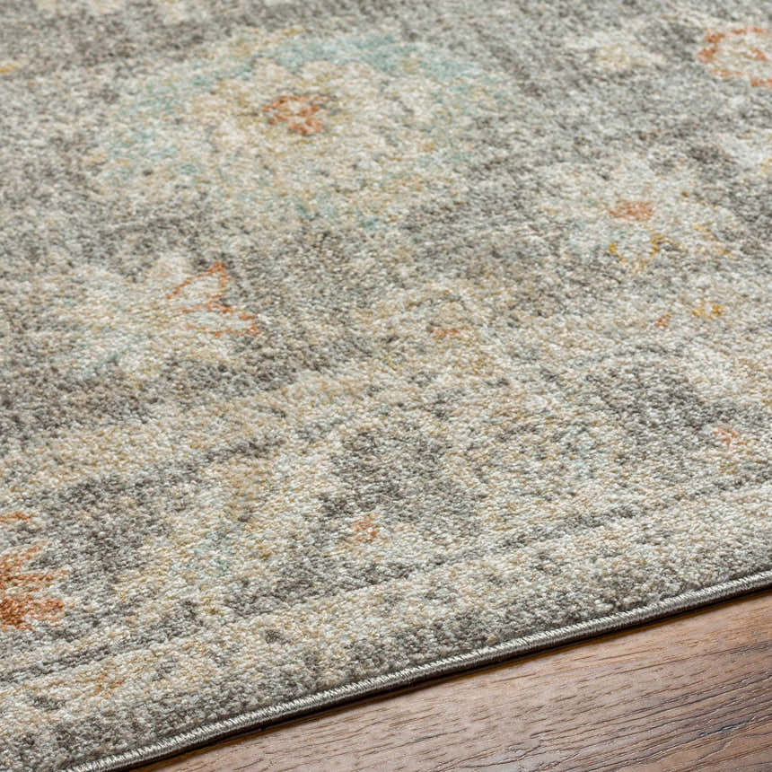 Close-up of the Ixtli Green & Gold Area Rug, featuring a traditional gray, gold, and brown pattern. Polypropylene texture. Texture