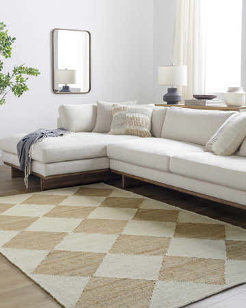 Living room scene with a beige sectional sofa and the Sondo Beige Area Rug with a diamond pattern. Roomscene-Rectangle
