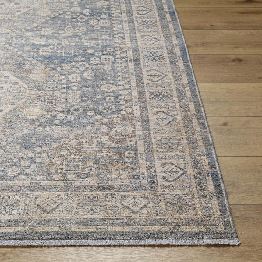 Close up of the Artan Area Rug showcasing its traditional gray, beige, and blue pattern on a wood floor. Front