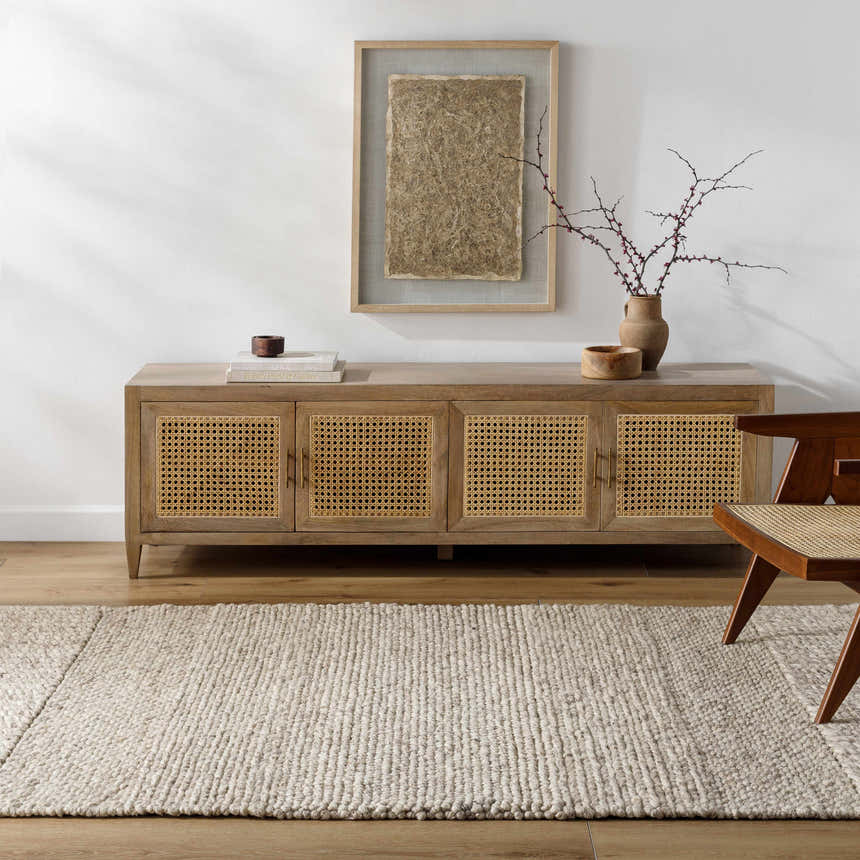 Living room scene with a beige Nimai Wool Area Rug, wood console table, and modern chair. Roomscene-Rectangle