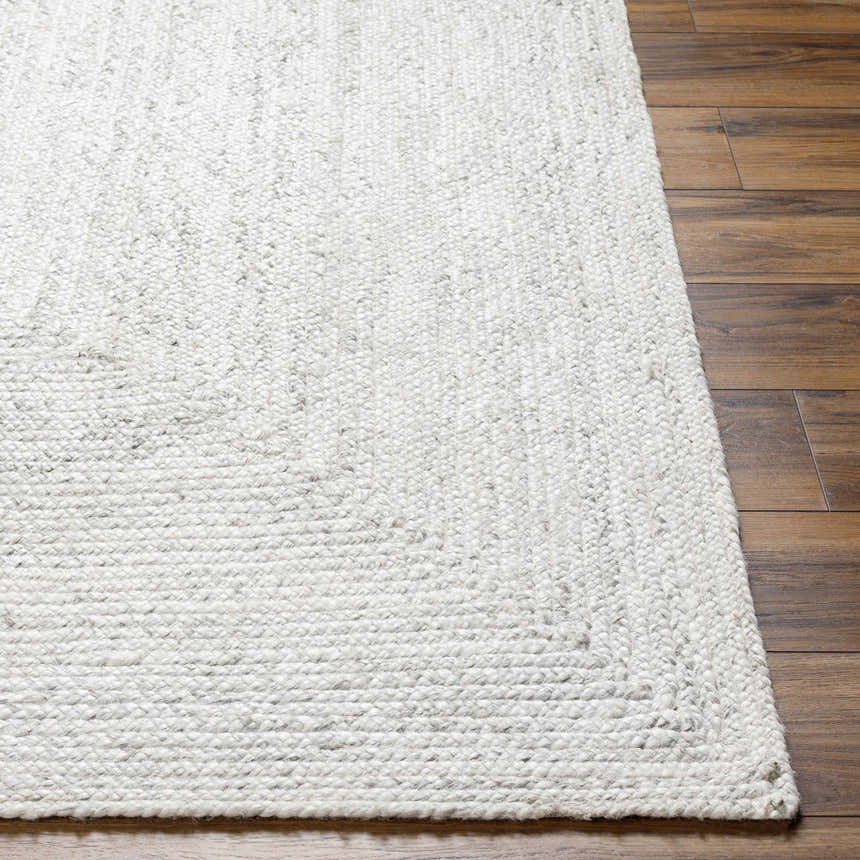 Close up of the hand woven Kenyi Rose Cream Area Rug showing texture and neutral colors. Front