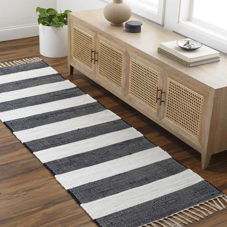 Entryway with wood floors, console table, and striped Moby Charcoal Area Rug runner. Roomscene-Runner