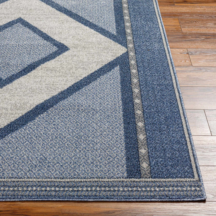 Close-up of the Onan Area Rug in Arctic Sky. Geometric pattern with blue, gray, and silver tones. Machine woven texture. Front