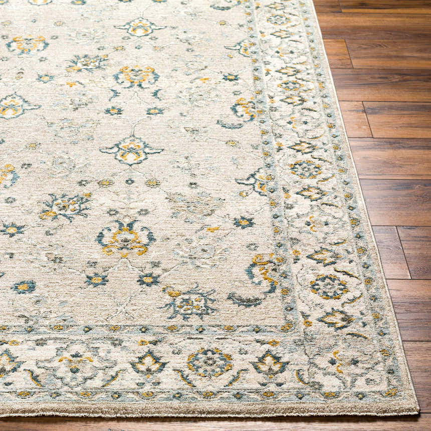 Close-up of the Amaru Cream & Sage Textured Rug. Features a traditional floral pattern in sage, teal, mustard, and cream. Front