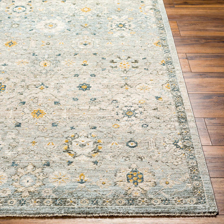 Close-up of the Annie Green Textured Rug with Fringes, showcasing its traditional floral pattern in blue and gold on a light green base. Front