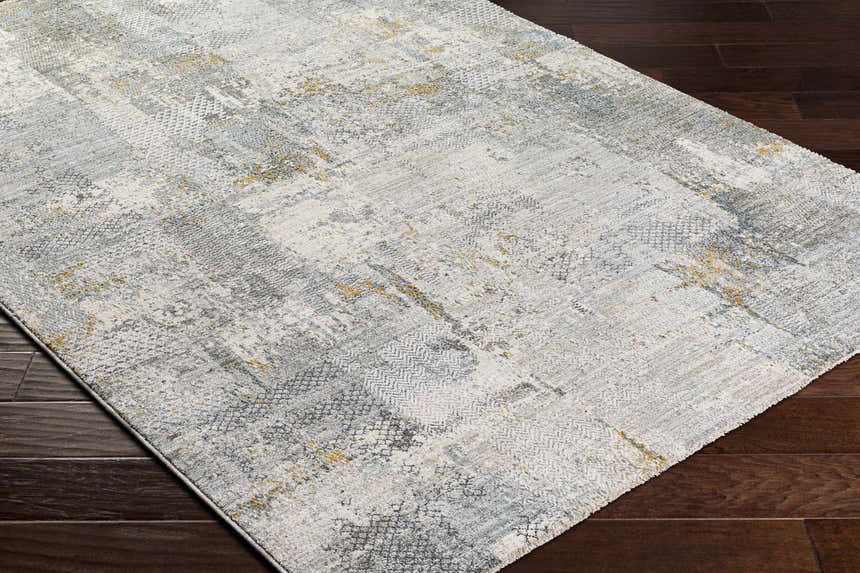 Close-up of the Elina Textured Abstract Rug. Features dusty sage, ink blue, and mustard hues in a contemporary design. Corner