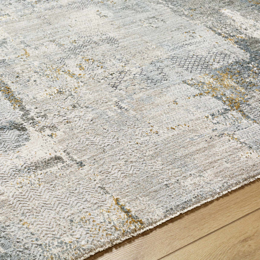 Close-up of the Elina Textured Abstract Rug. Off-white, light gray, and mustard hues create a contemporary design. Texture